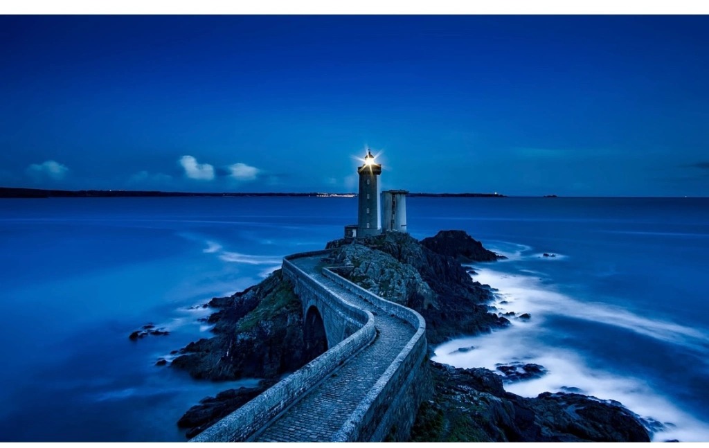lighthouse signal winding path on a rocky cliff